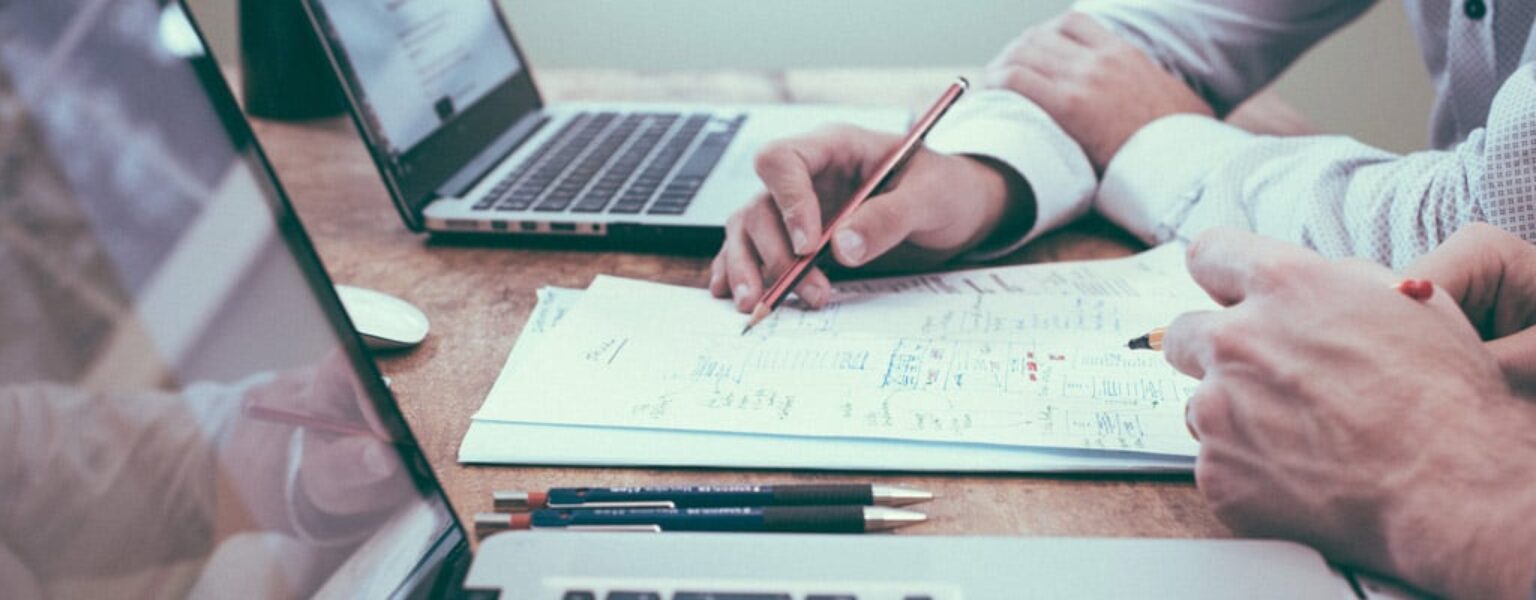 Close up of business men reviewing records and charts