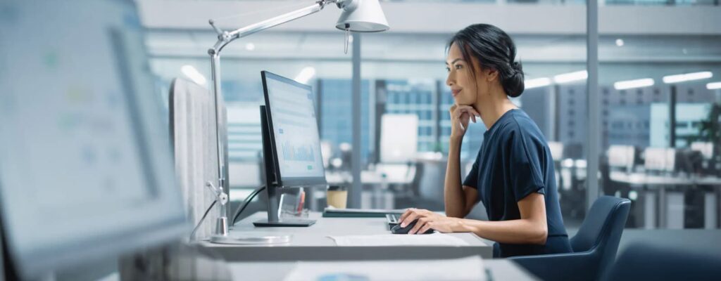 A woman working in an office utilizing cloud continuity features