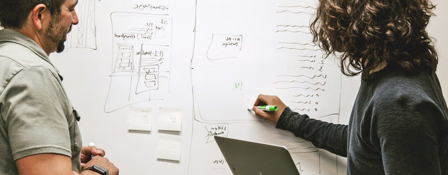 Two people reviewing common cloud migration challenges