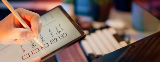 Business owner creating a cybersecurity checklist on an ipad