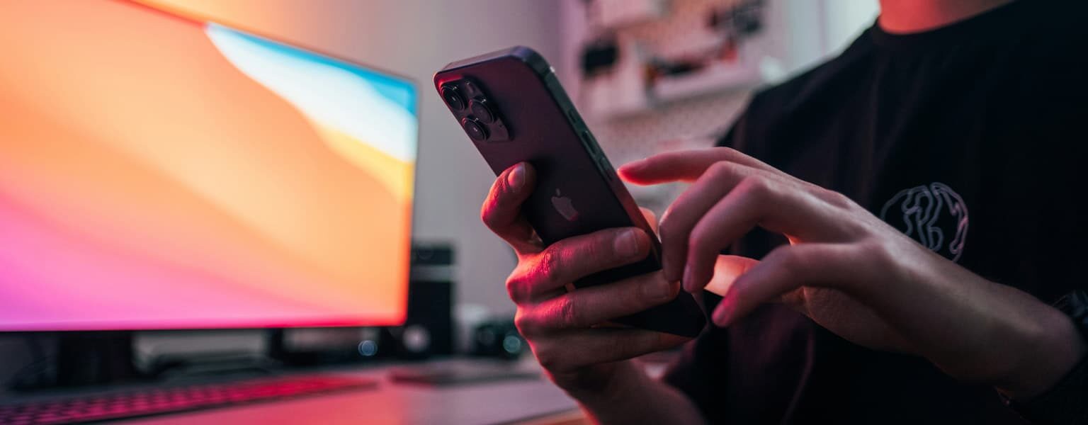 Man dealing with IRSF Toll Fraud on cell phone